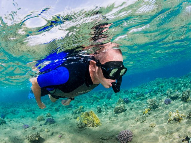 Beginner Snorkeller exploring the reef in shallow waters